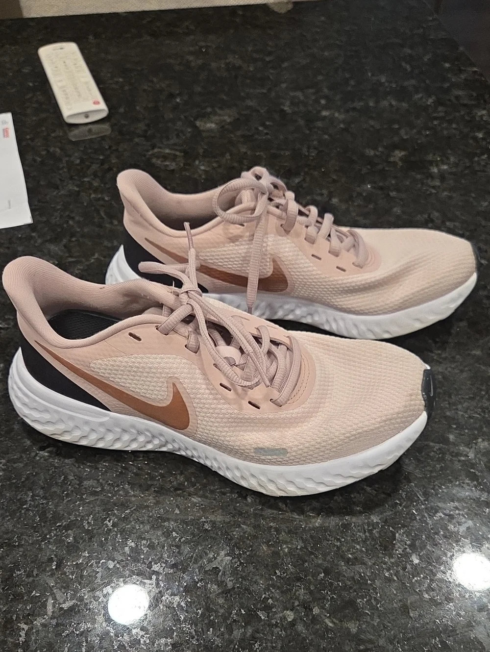 Nike Revolution Women’s Blush Pink Athletic Running Shoes with Rose-Gold Swoosh.